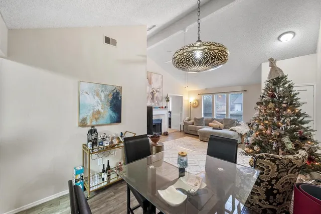 a living room with fireplace furniture and a chandelier