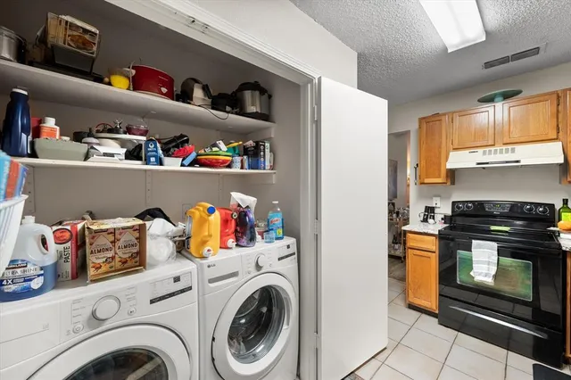 a view of storage and utility room with washer and dryer