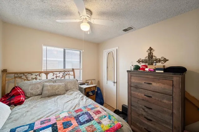 a bed room with a bed and a chandelier