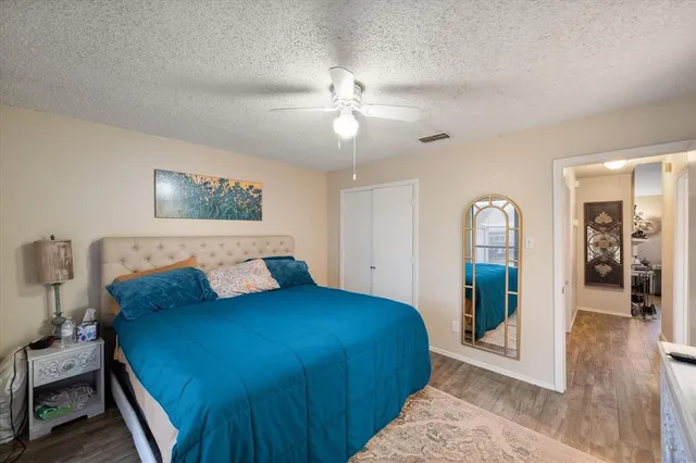 a bedroom with a large bed and a chandelier