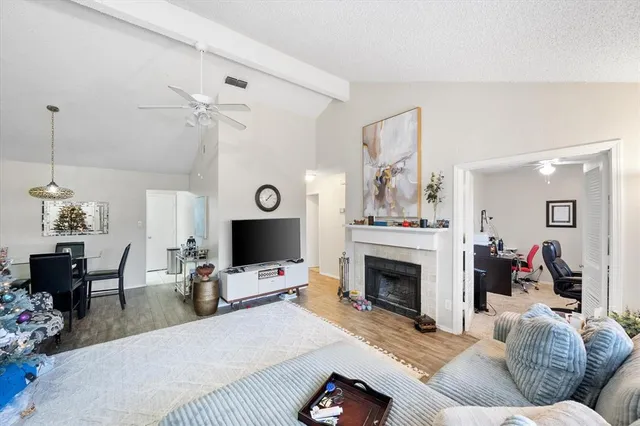 a living room with furniture a fireplace and a flat screen tv