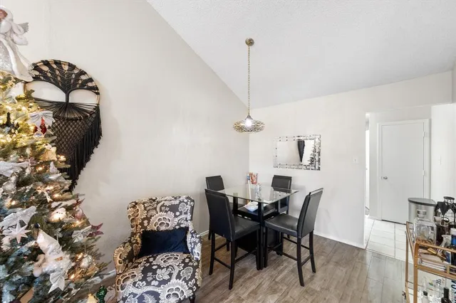 a view of a dining room with furniture and a chandelier