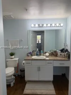 a spacious bathroom with a toilet sink and mirror