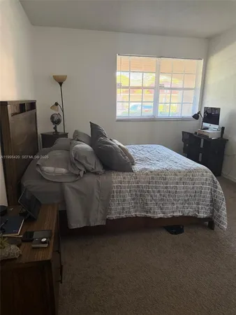 a bedroom with bed and window