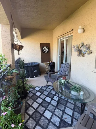 a view of a house with backyard porch and furniture