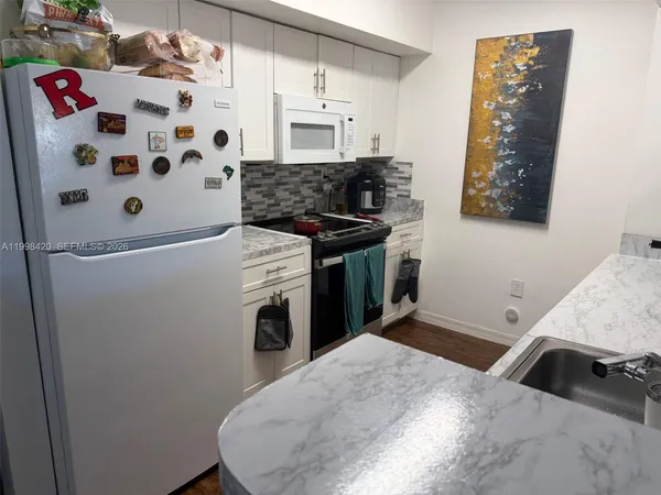 a kitchen with a stove and a refrigerator