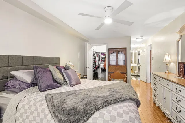 a bedroom with a large bed and a chandelier