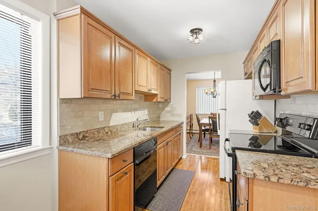 a kitchen with a stove a sink and a refrigerator