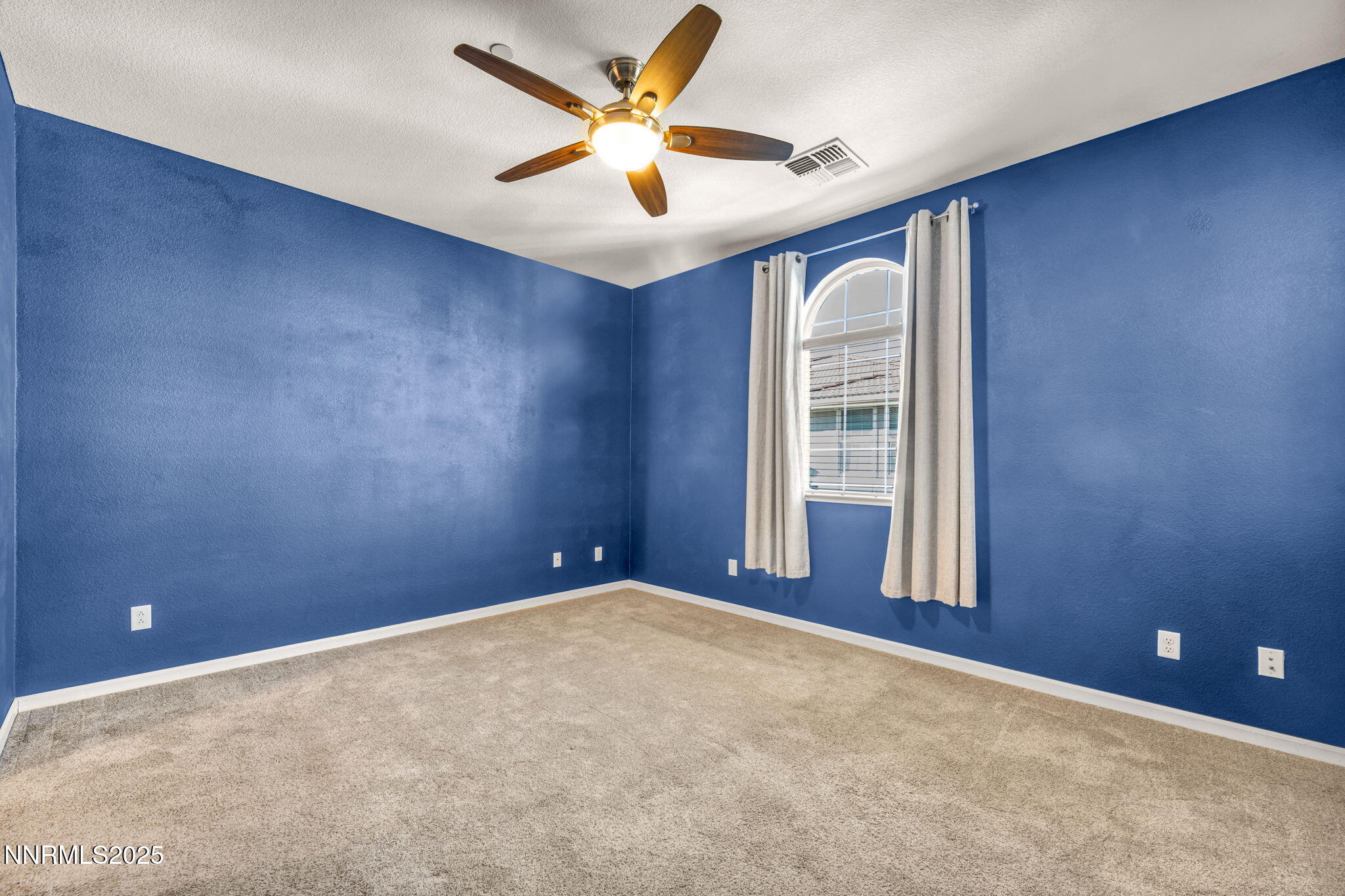 1864 Wind Ranch Road, Unit C Reno, NV 89521 - Photo 13 of 49 an empty room with a window and a ceiling fan