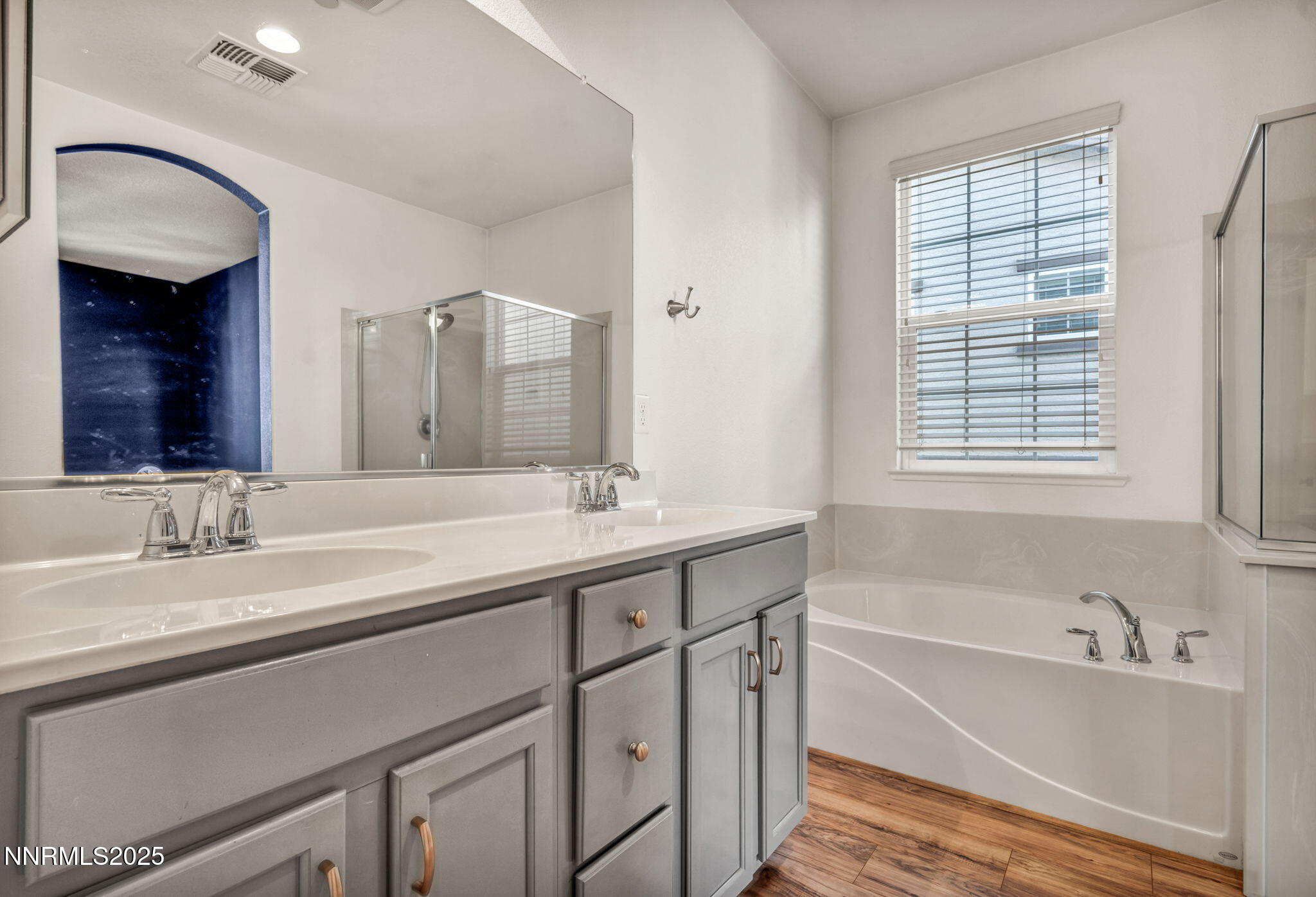1864 Wind Ranch Road, Unit C Reno, NV 89521 - Photo 17 of 49 a bathroom with a tub double sink window and mirror
