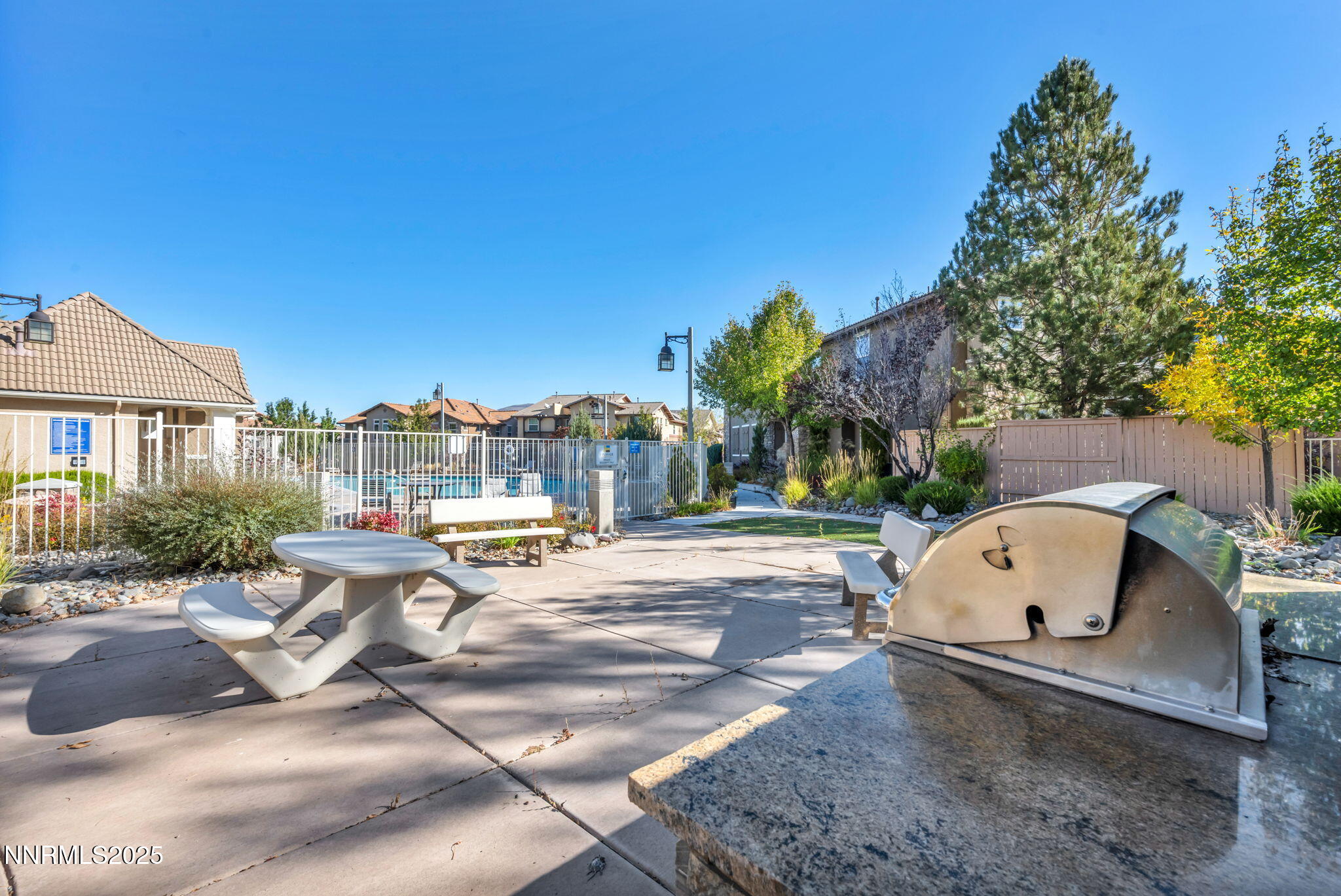 1864 Wind Ranch Road, Unit C Reno, NV 89521 - Photo 35 of 49 a view of a patio with a table and chairs
