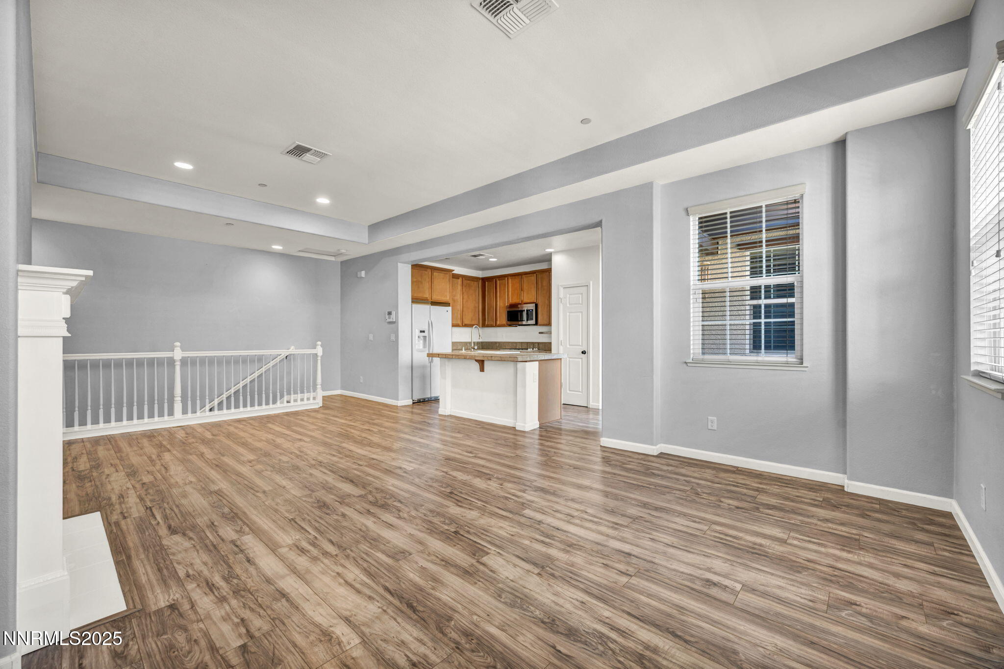 1864 Wind Ranch Road, Unit C Reno, NV 89521 - Photo 8 of 49 a view of an empty room with wooden floor and a window