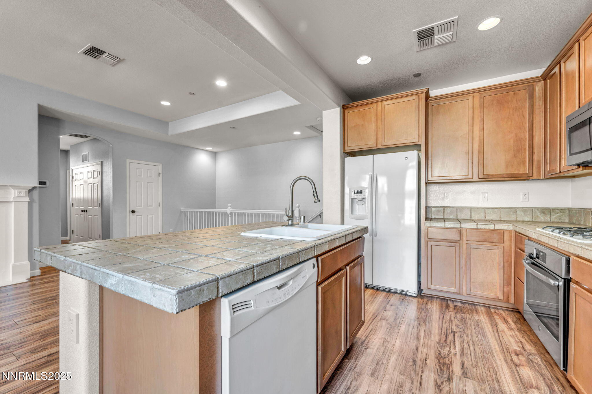 1864 Wind Ranch Road, Unit C Reno, NV 89521 - Photo 10 of 49 a kitchen with sink cabinets and wooden floor