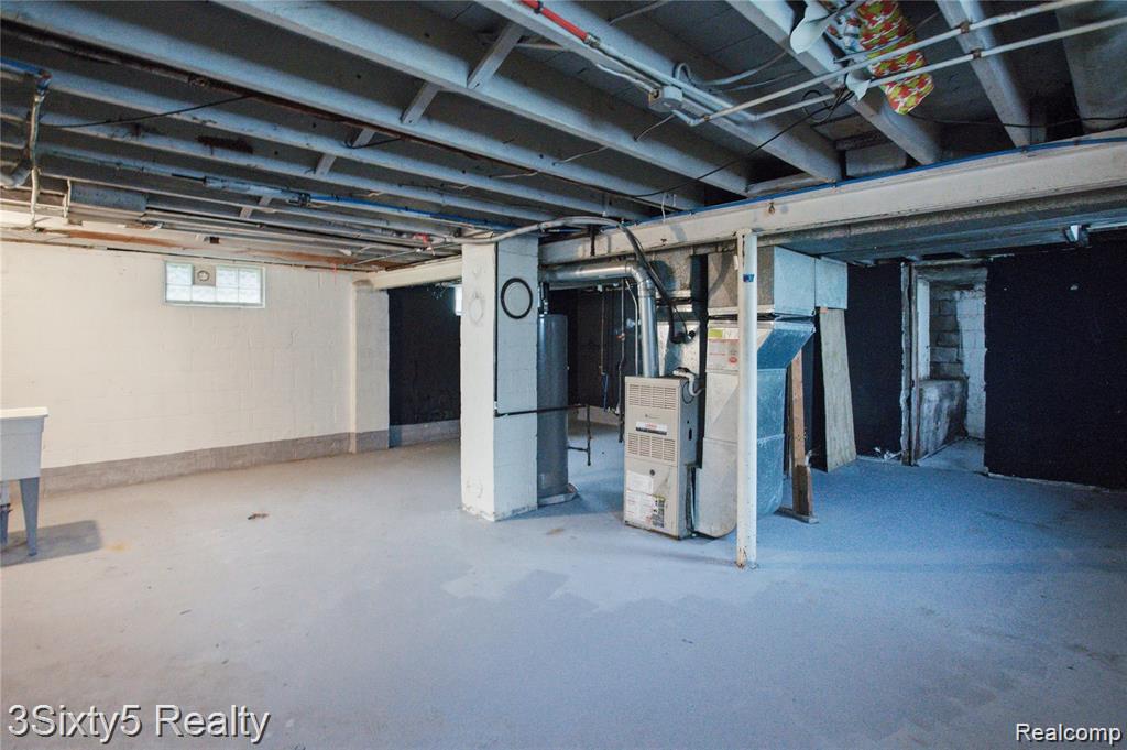 147 Charles Street River Rouge, MI 48218 - Photo 15 of 24 Unfinished lower level featuring exposed ceiling joists, concrete flooring, and a utility sink