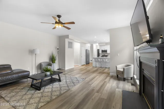 a living room with furniture and a potted plant