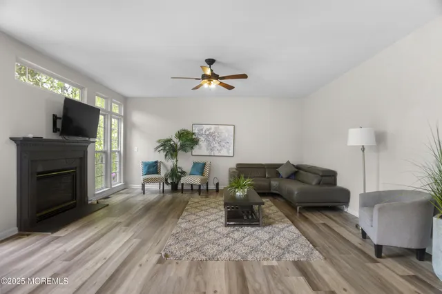 a living room with furniture window and wooden floor