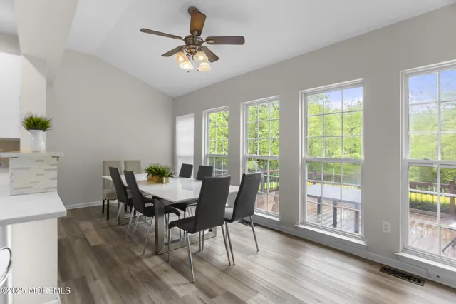 a bedroom with a bed window and a flat screen tv
