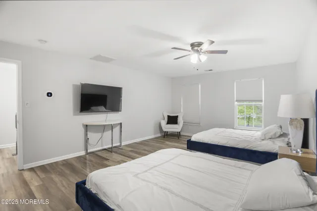 a bedroom with a bed a window and a chandelier