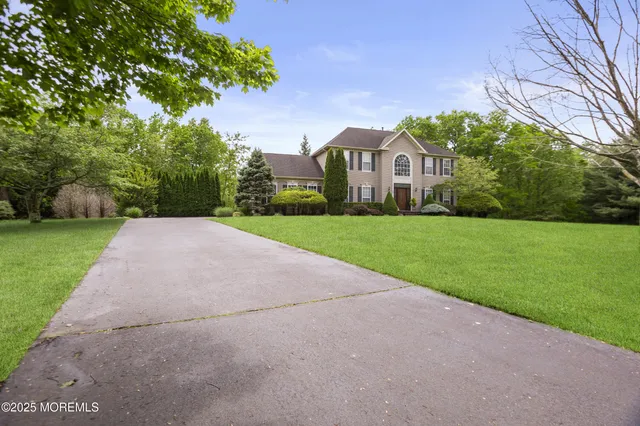 a view of a house with a yard and garage