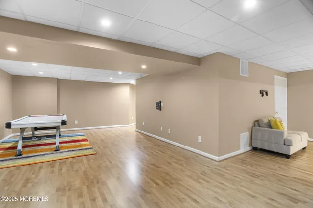 an aerial view of a house with garden space and trees all around