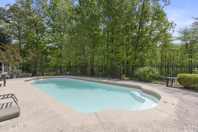 an aerial view of a house with a swimming pool
