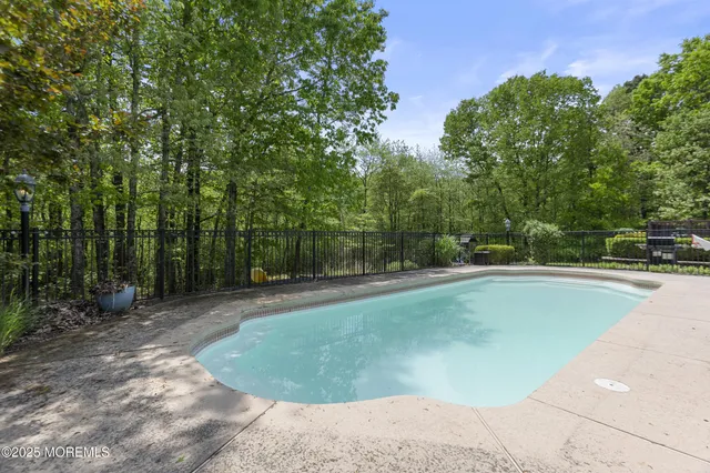 an aerial view of a house with a garden and swimming pool