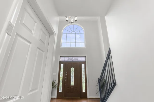 a kitchen with stainless steel appliances granite countertop a stove top oven a sink dishwasher a dining table and chairs with wooden floor