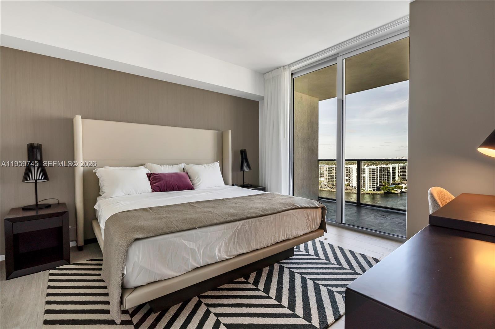 4010 South Ocean Drive, Unit R2301 Hollywood, FL 33019 - Photo 12 of 33 a bedroom with a bed and wooden floor