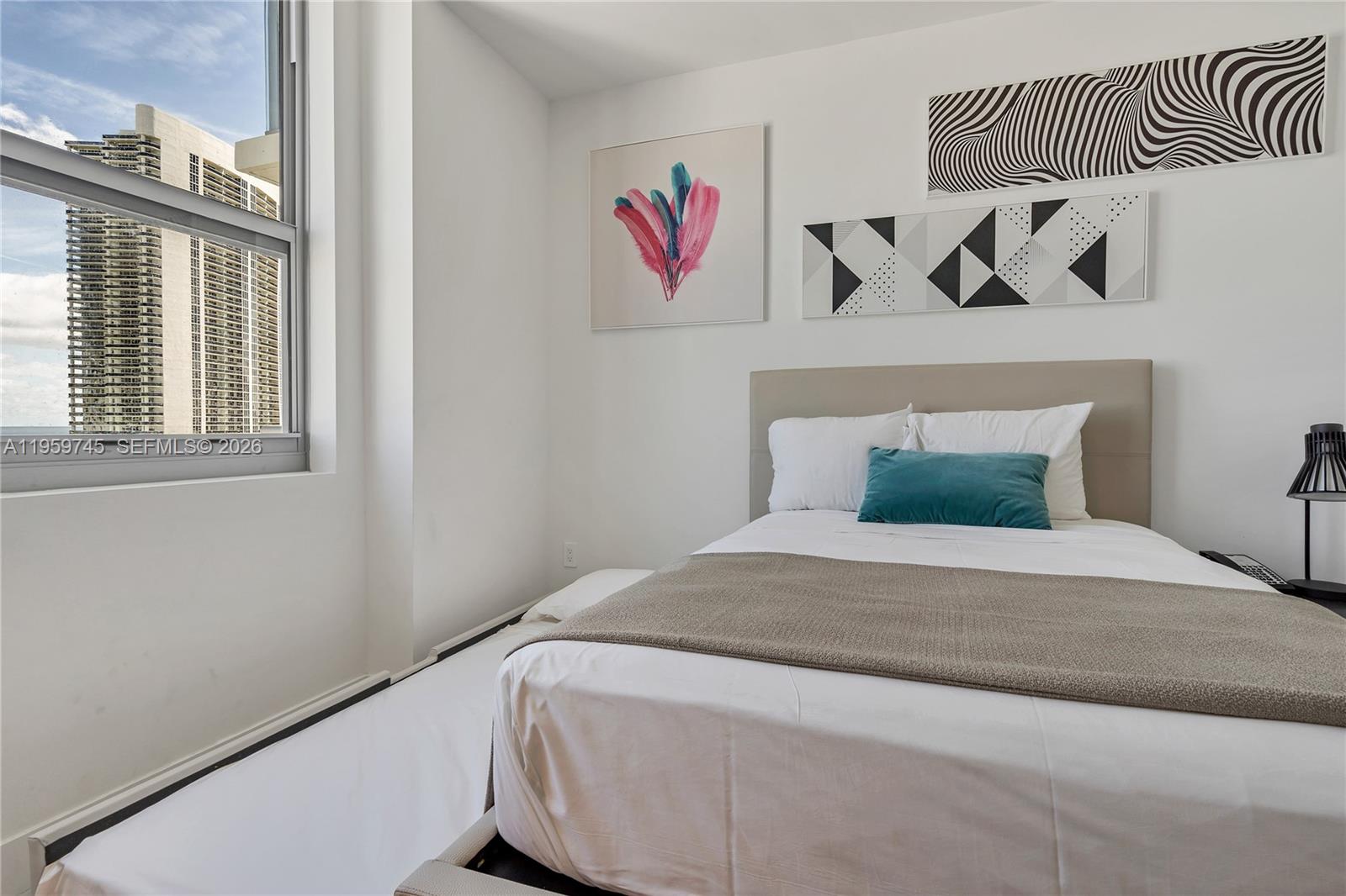 4010 South Ocean Drive, Unit R2301 Hollywood, FL 33019 - Photo 15 of 33 a bedroom with a bed and a window