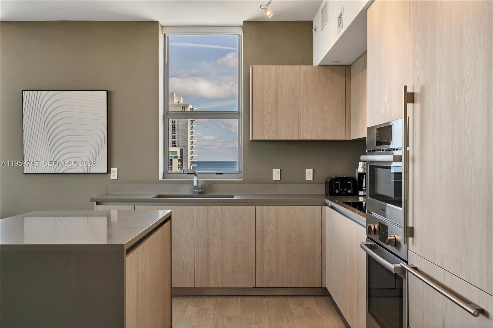 4010 South Ocean Drive, Unit R2301 Hollywood, FL 33019 - Photo 6 of 33 a kitchen with a sink appliances and cabinets