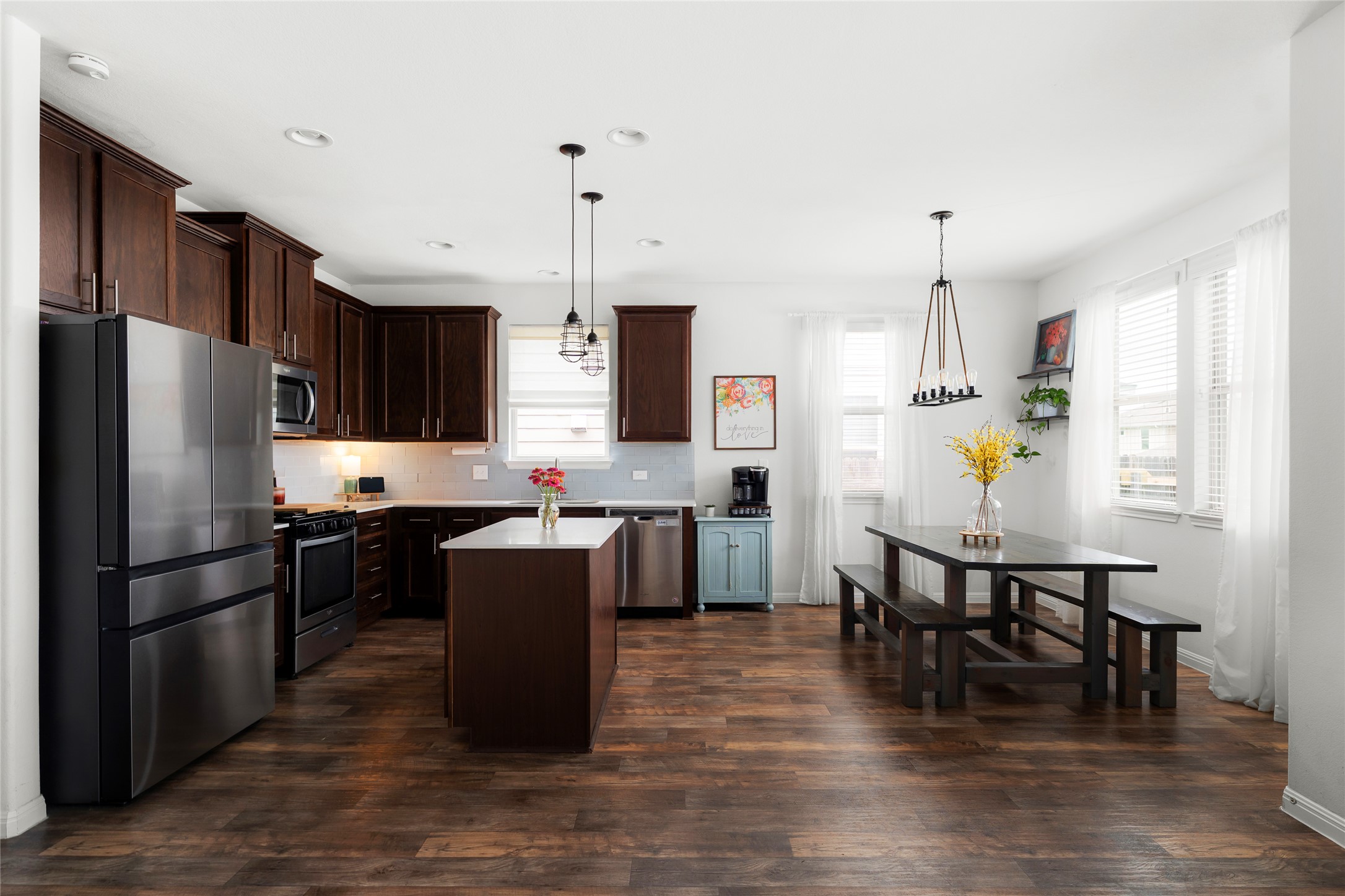 249 Wapiti Road Buda, TX 78610 - Photo 7 of 21 A well-appointed kitchen features rich cabinetry, stainless steel appliances, and an inviting dining area.