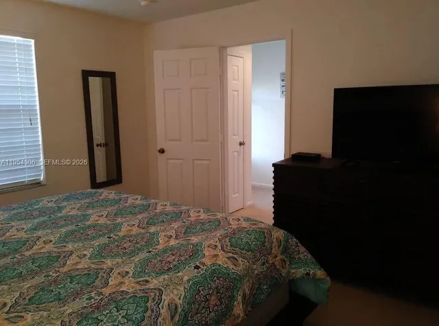 a bedroom with a bed and a window