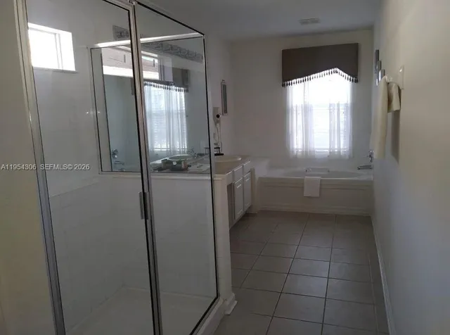 a kitchen with a refrigerator and window