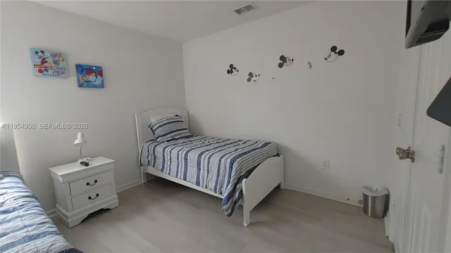 a bedroom with a bed and a dresser in it