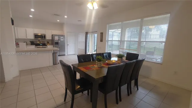 a view of a dining room with furniture and window