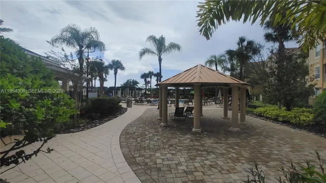 a backyard of a house with a garden and outdoor seating