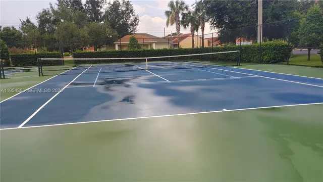 a kitchen with kitchen island a sink table and chairs
