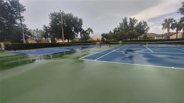 a room with furniture pool table gym equipment and a large window