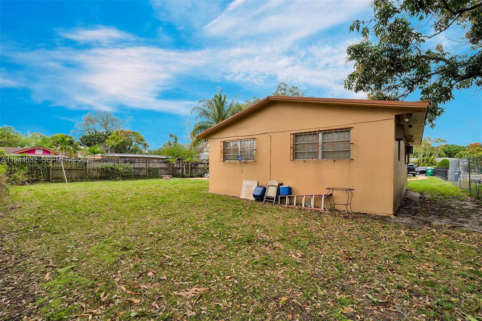 1900 Northwest 88th Street Miami, FL 33147 - Photo 23 of 31 a view of backyard of house with wooden fence