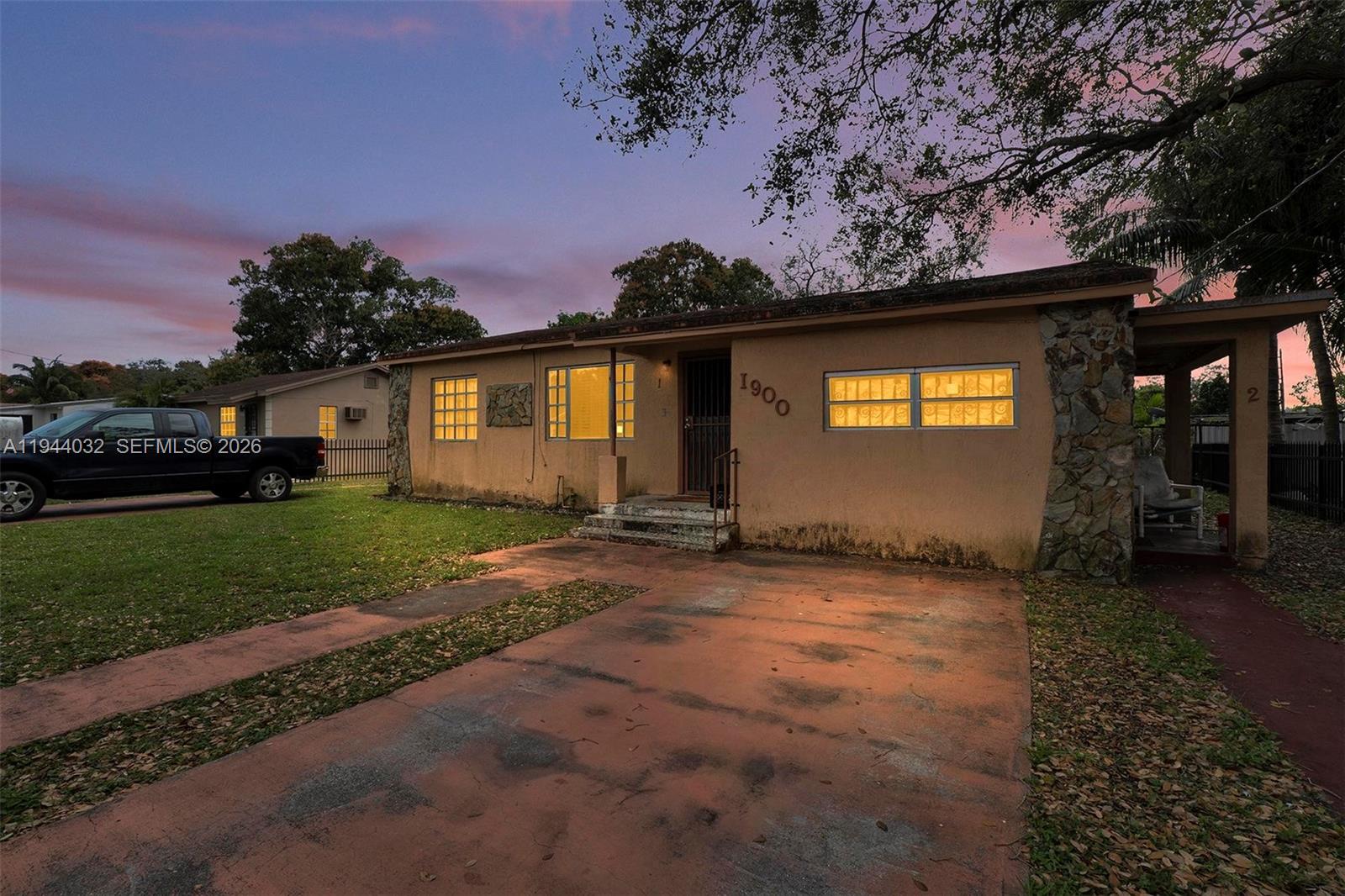 1900 Northwest 88th Street Miami, FL 33147 - Photo 31 of 31 a view of a house with a yard and garage