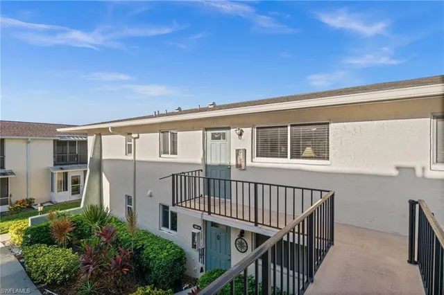 a view of a house with wooden deck