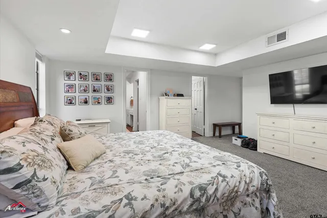 a bedroom with a bed and flat screen tv