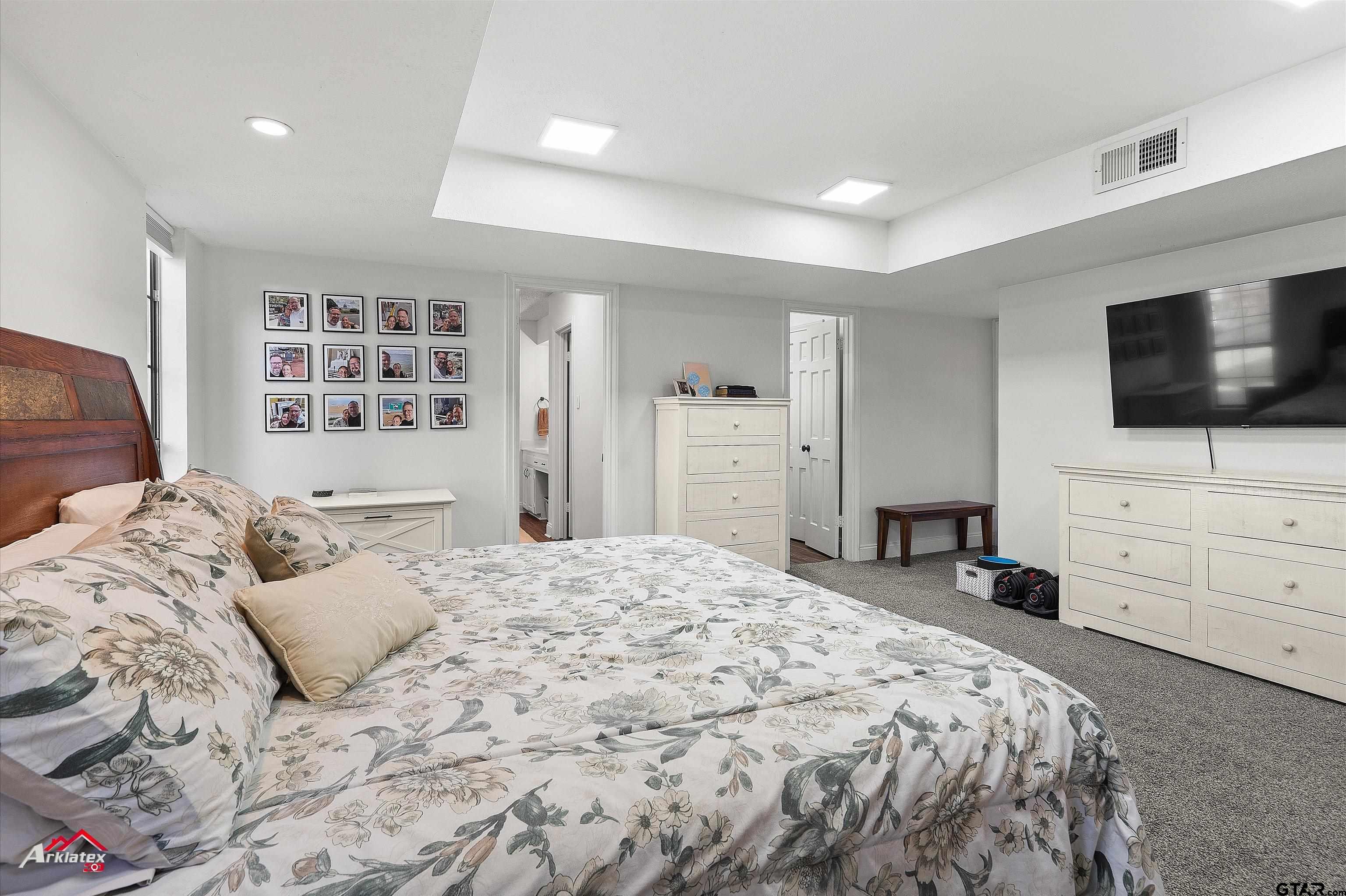 914 Regency Drive Longview, TX 75604 - Photo 12 of 35 a bedroom with a bed and flat screen tv