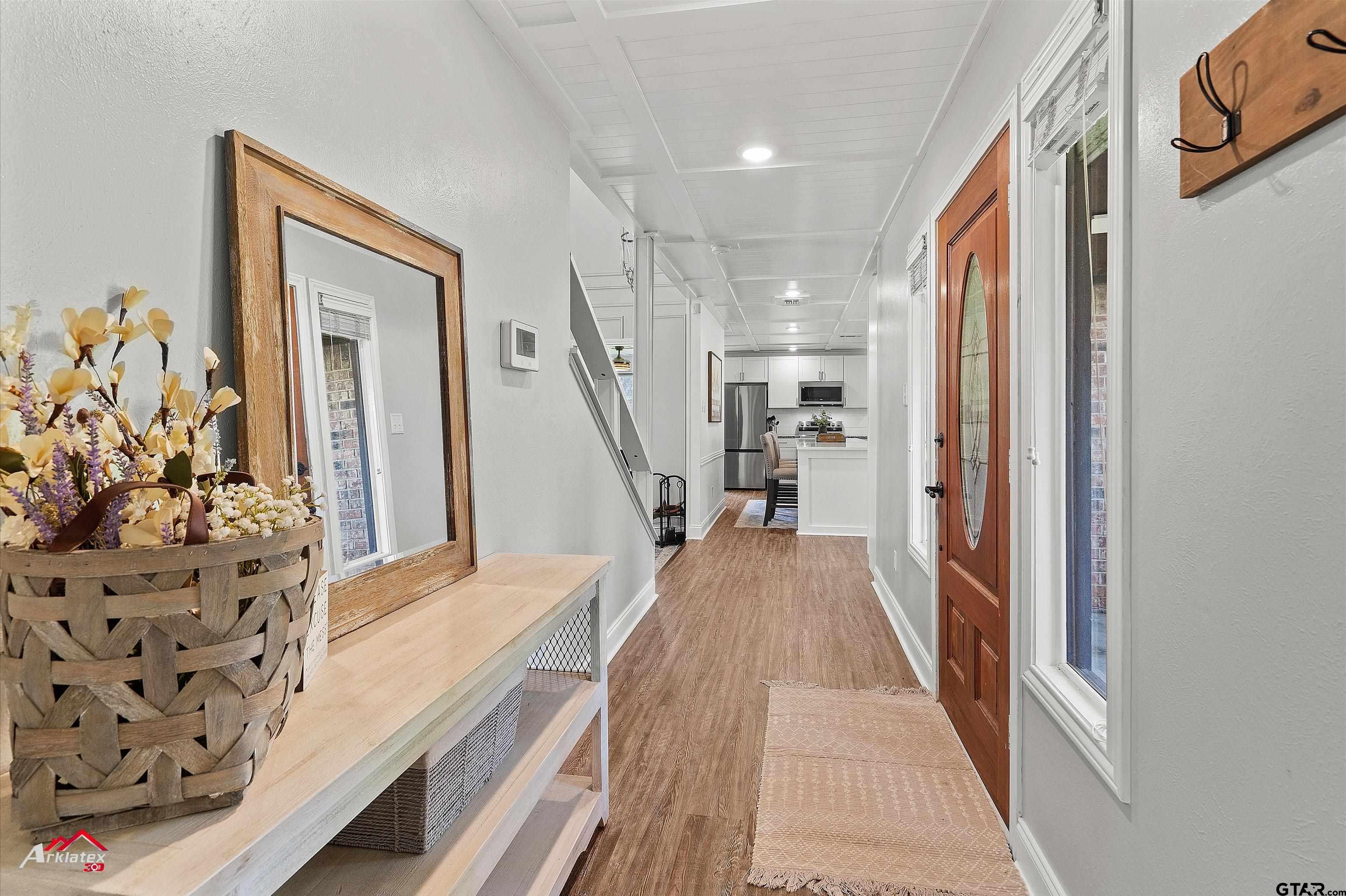 914 Regency Drive Longview, TX 75604 - Photo 15 of 35 a view of a hallway with wooden floor and stairs