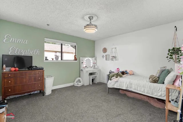 a bedroom with furniture and a flat screen tv