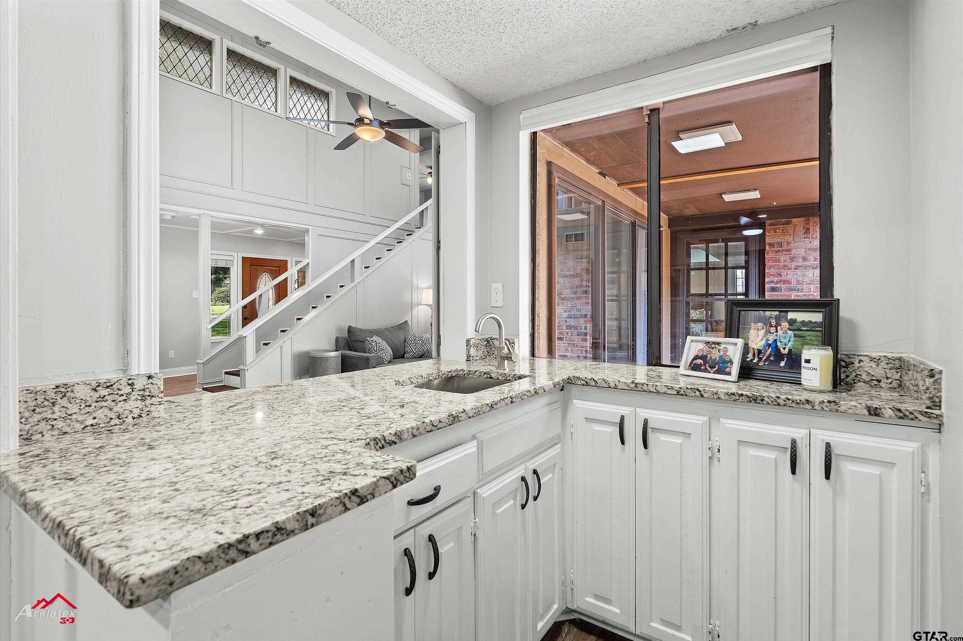 914 Regency Drive Longview, TX 75604 - Photo 20 of 35 a bathroom with a granite countertop sink and a mirror