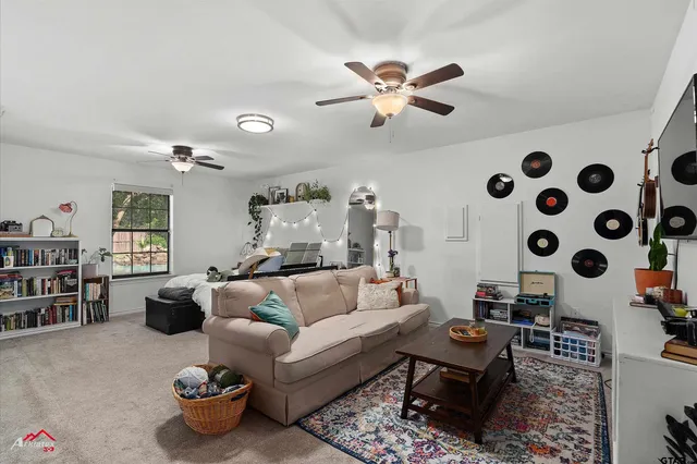 a kitchen with a table chairs microwave and refrigerator