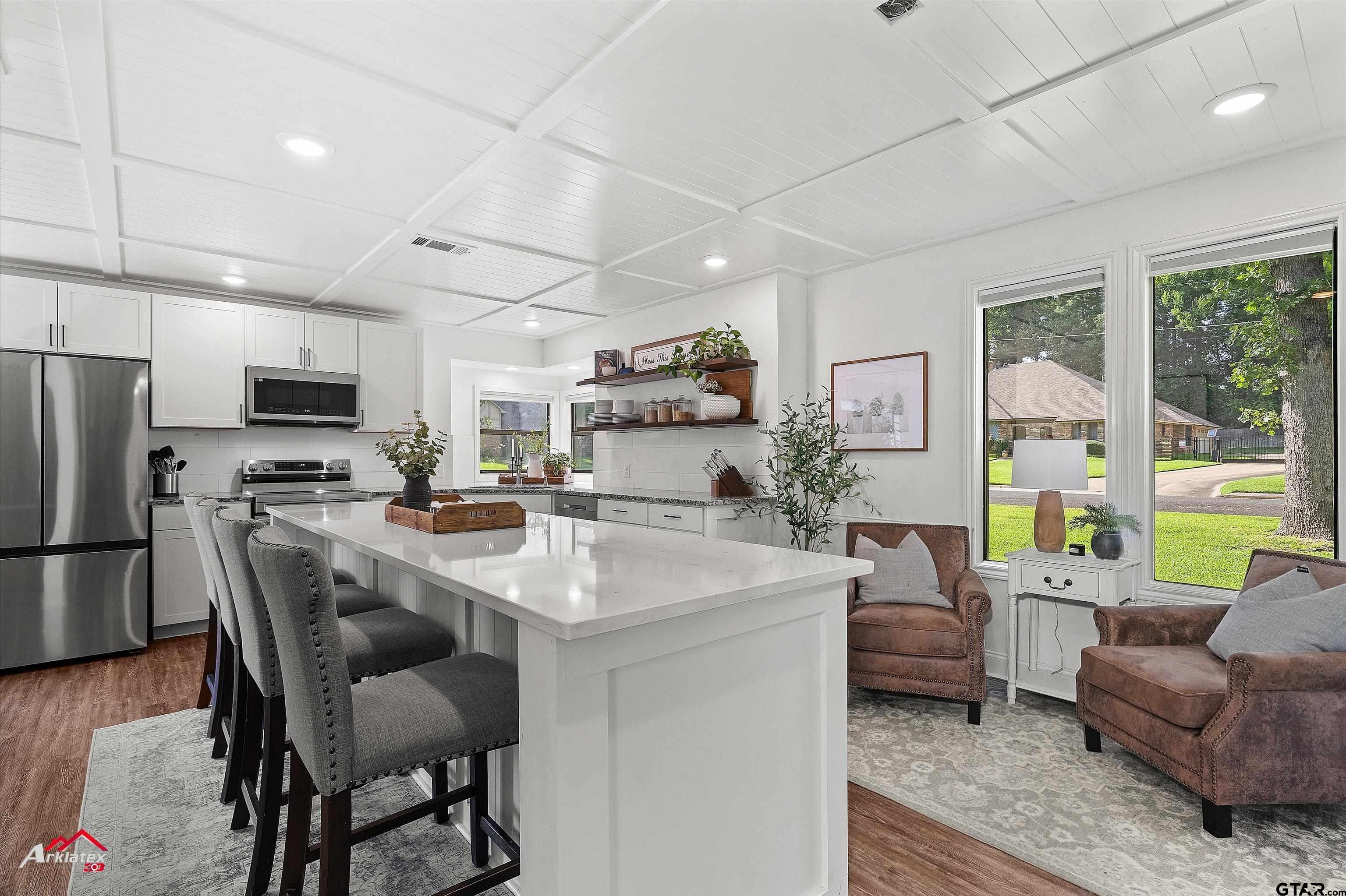 914 Regency Drive Longview, TX 75604 - Photo 29 of 35 a view of kitchen with stainless steel appliances granite countertop a sink a stove a refrigerator cabinets and chairs