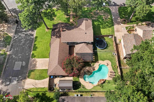 an aerial view of a house with a yard and potted plants