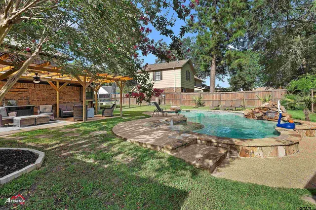 a view of backyard with deck and garden